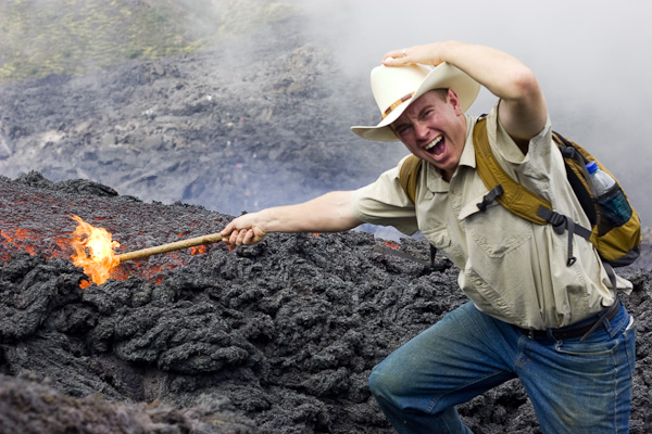 John pushing a stick into Lava on the Pacaya Volcano, Guatemala